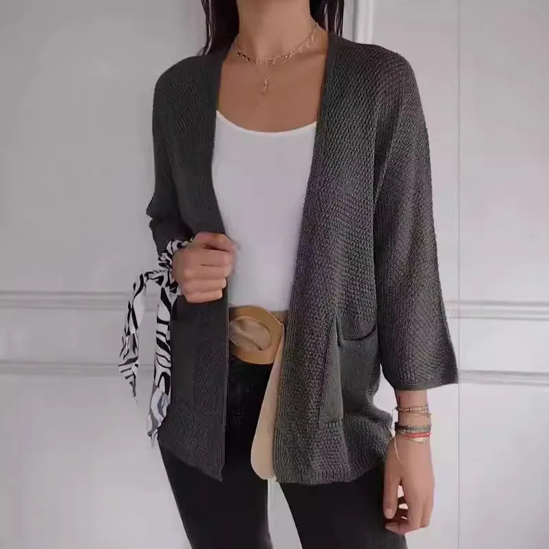 Women's waffle knit cardigan coat with nine-quarter sleeves in army green colour showing pocket detail