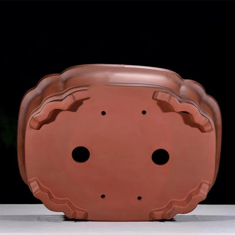 Large antique-style purple clay Chinese flower pot showing wide, shallow shape.