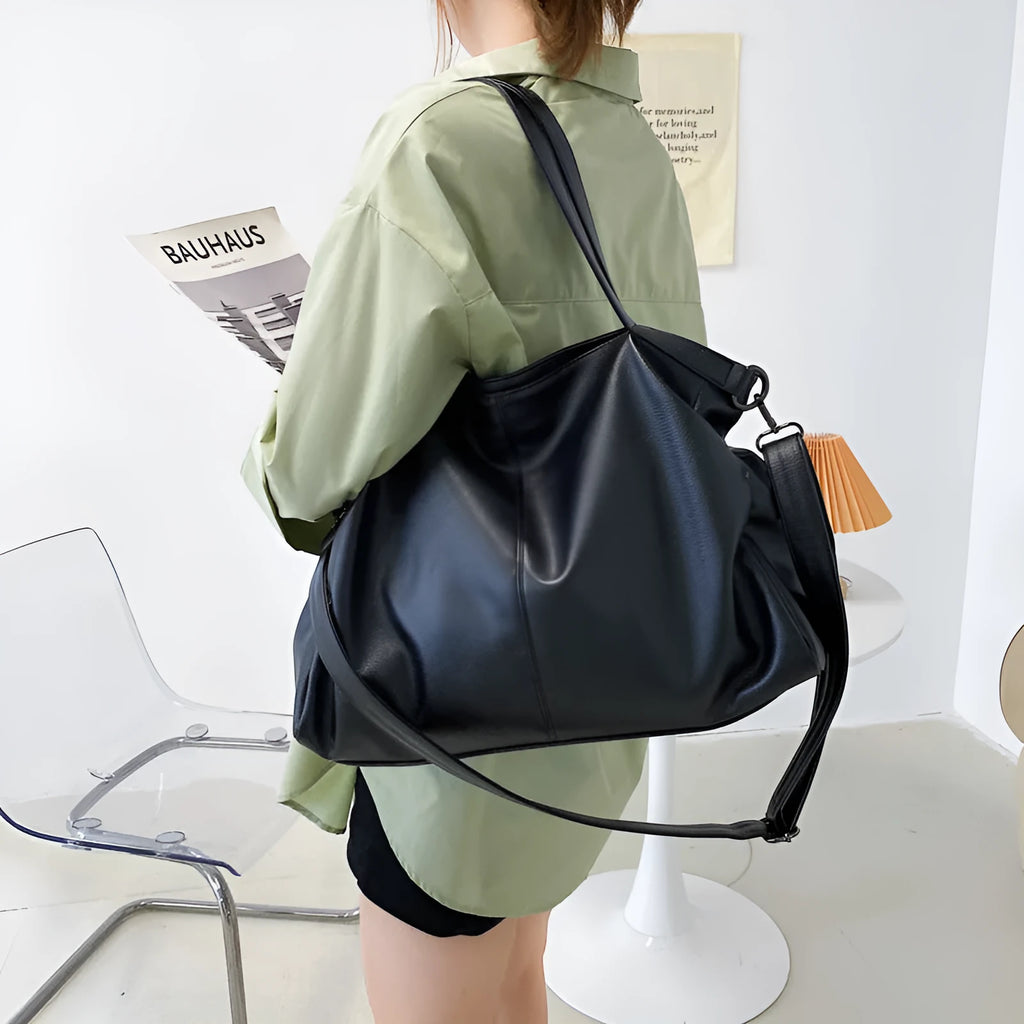 Large soft surface PU messenger tote bag in a horizontal square shape with a zip top and long shoulder strap.