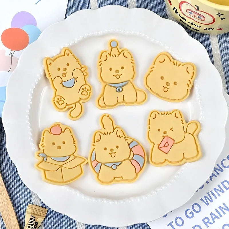 Plastic biscuit mould with puppy cartoon designs including birthday hats and swimming rings