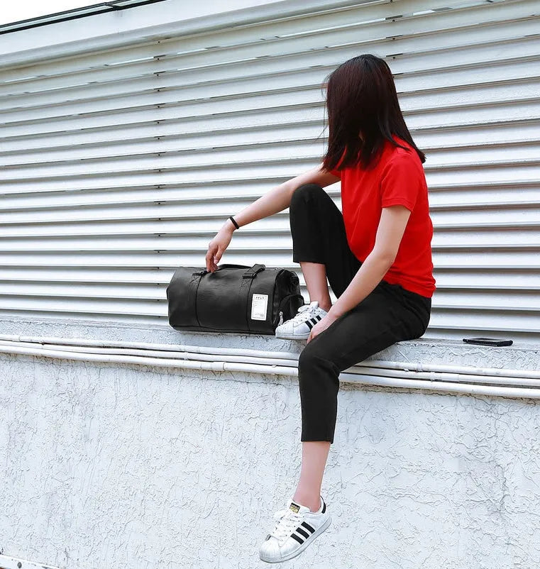 Black waterproof sports bag with diagonal strap and separate shoe compartment