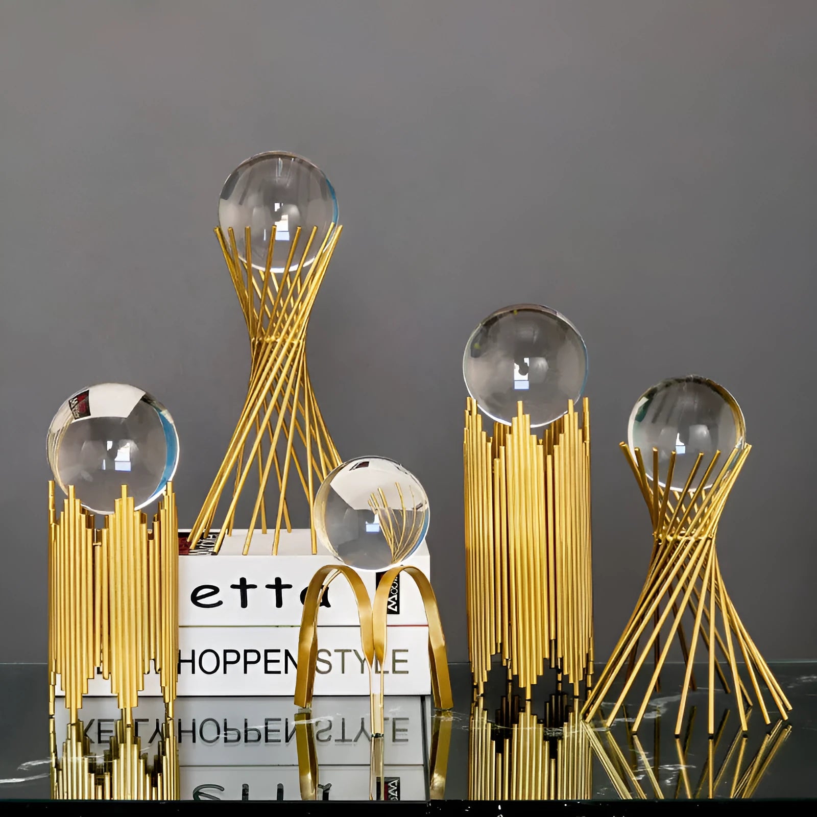 Nordic gold metal crystal ball ornament on a table, abstract shape with clear glass ball