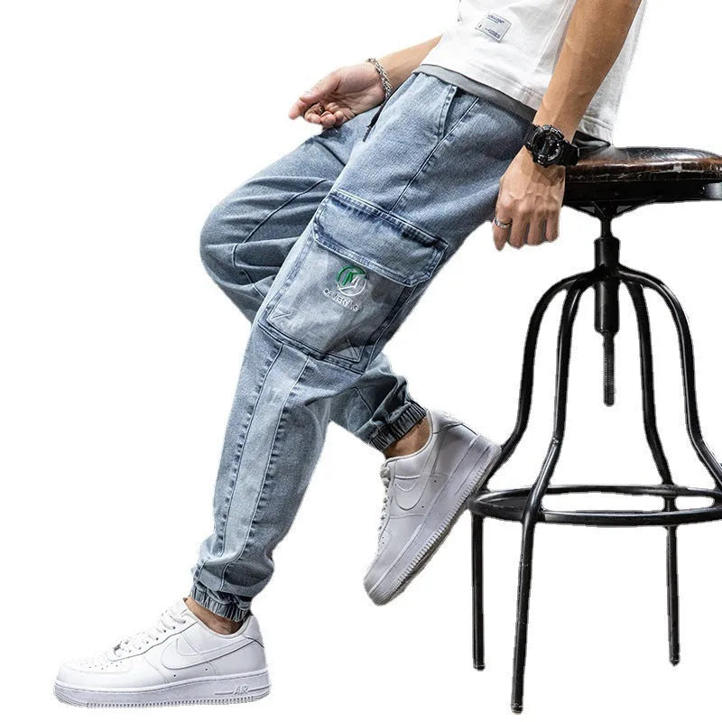 Man wearing loose blue cargo jeans with a straight leg and micro-elastic cotton fabric.