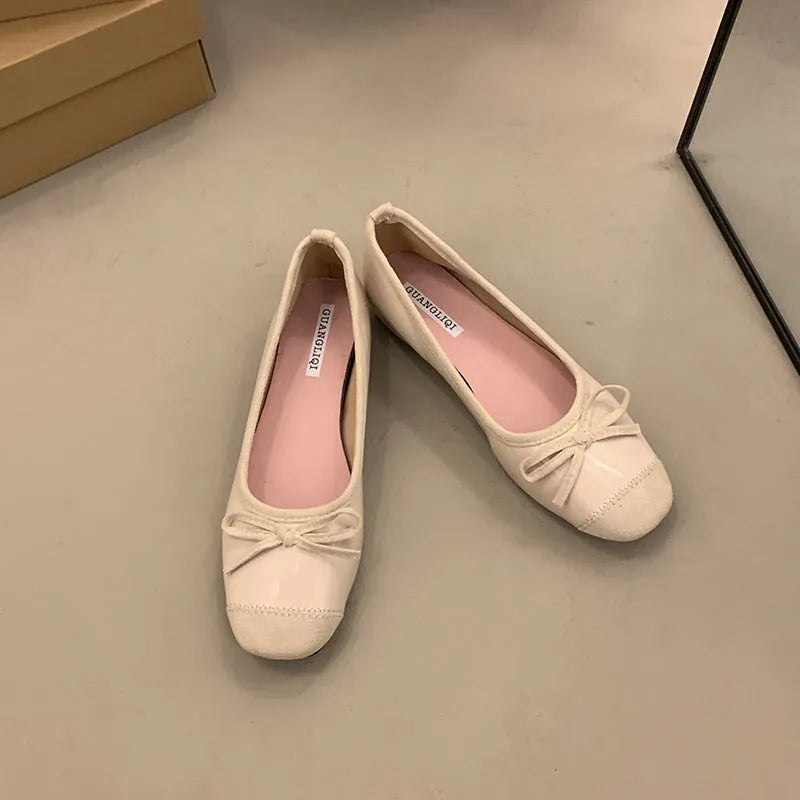 Retro apricot colour Mary Jane ballet flats with bow detail and square toe on a white background.