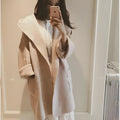 A plus-size woman wearing a loose grey cotton coat with lace details and long sleeves.