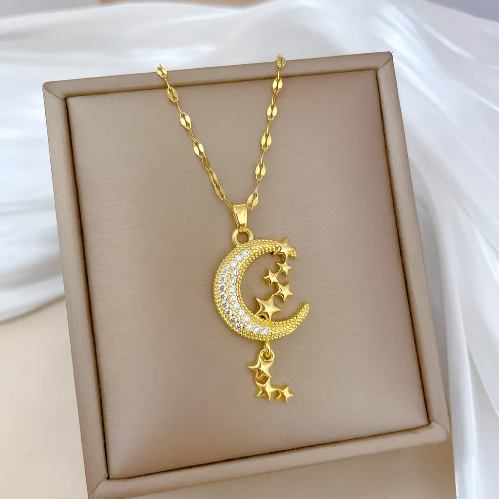 Moon pendant necklace with diamond accents and tassel on stainless steel chain