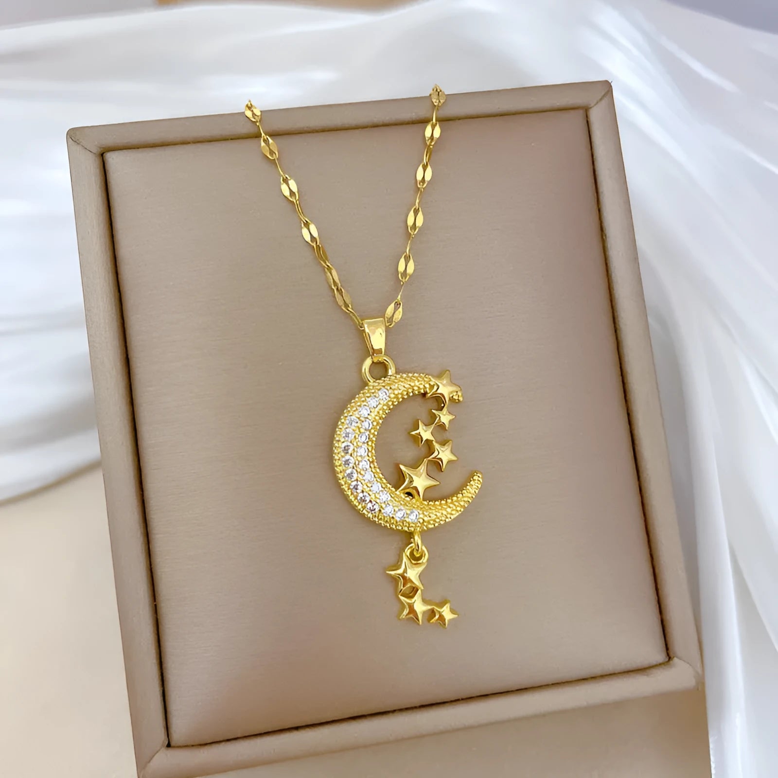 Moon pendant necklace with diamond accents and tassel on stainless steel chain