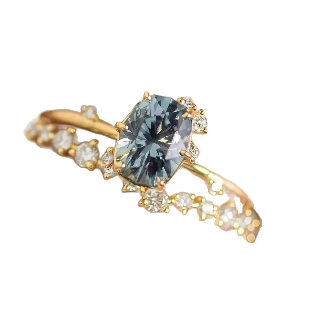 Gold plated floral women's ring with a central green zircon stone.