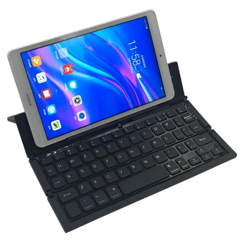 Black foldable ultra-thin wireless Bluetooth keyboard for tablets shown open next to a mobile phone.