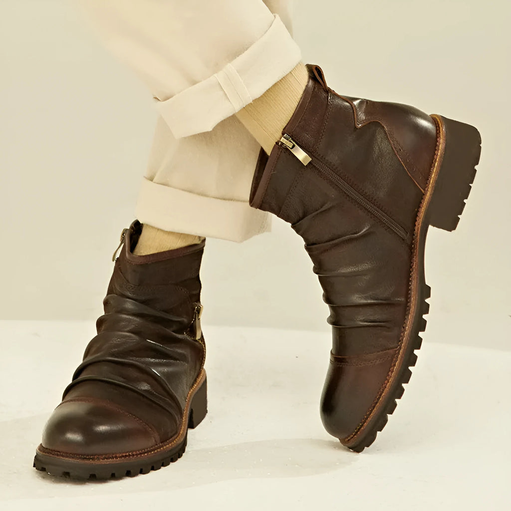 Black mid-calf cowboy boots with side zip, round toe, and embossed PU upper on a brown background.