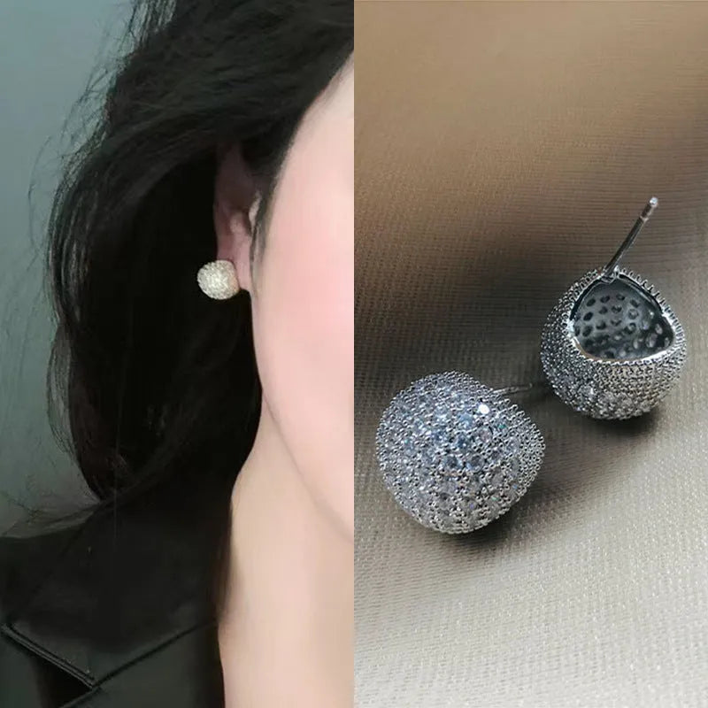 Geometric drop-shaped women's earrings with full diamond detailing and golden bean elements
