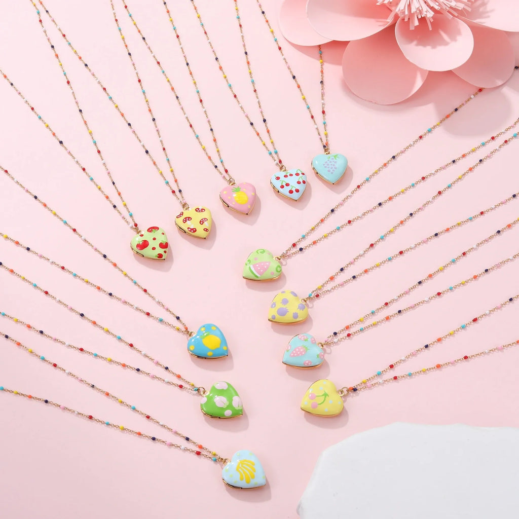 Stainless steel necklace with gold plated heart pendant featuring fruit design on adjustable chain