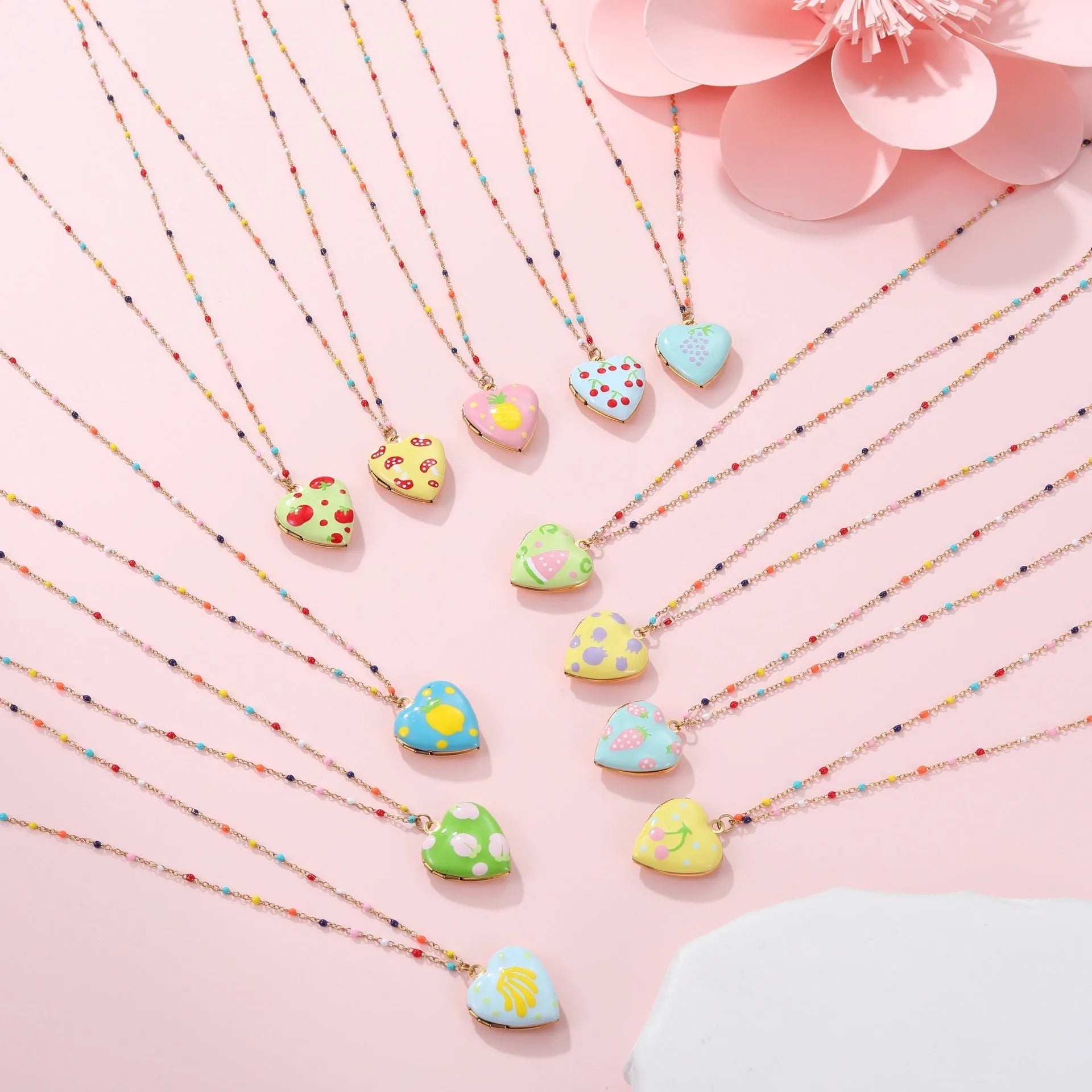 Stainless steel necklace with gold plated heart pendant featuring fruit design on adjustable chain