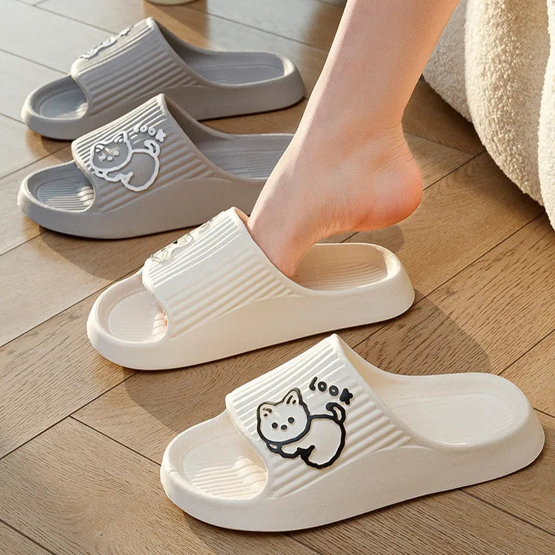 Green cat slippers with a thick EVA platform and non-slip sole on a wooden floor.
