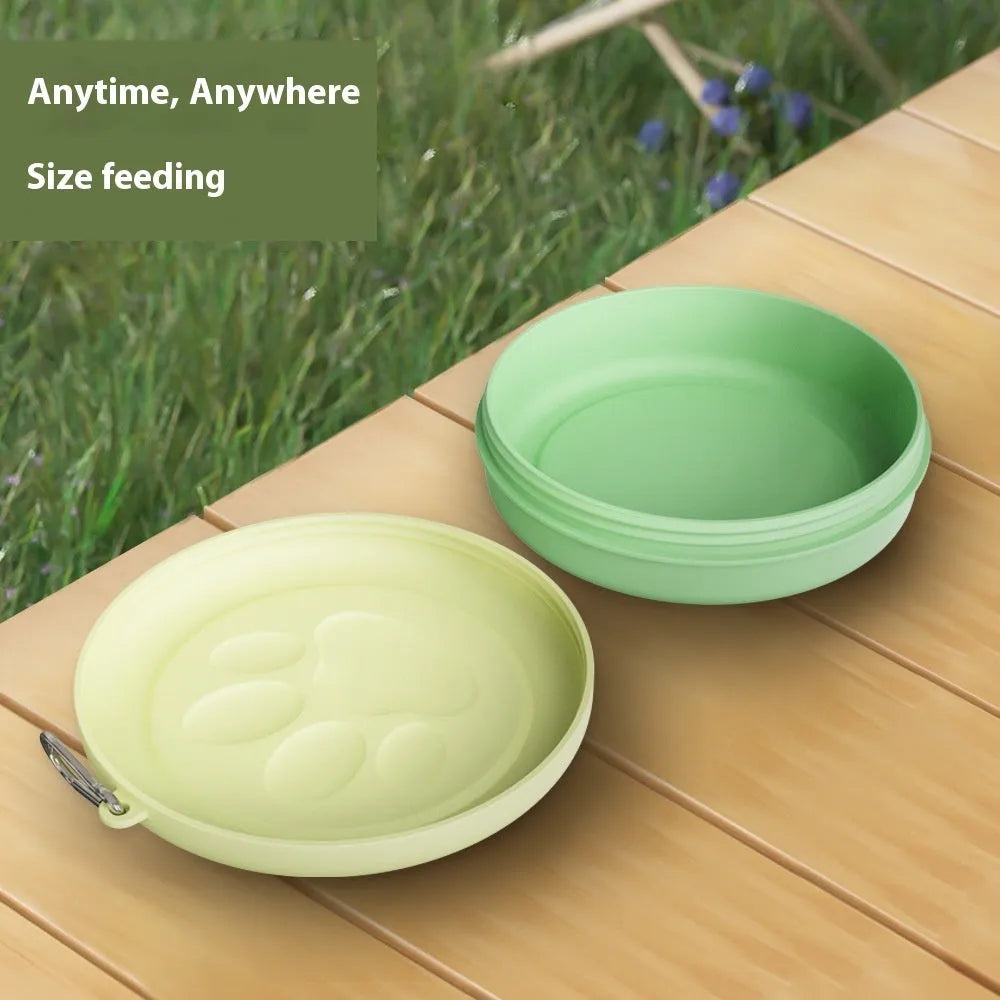 Portable plastic pet food bowl in light pink or green for outdoor travel feeding
