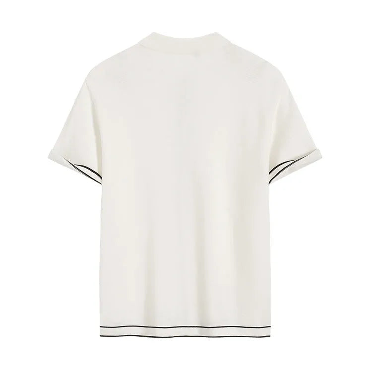 White women's short sleeve cardigan with dark contrast lapels on a hanger.
