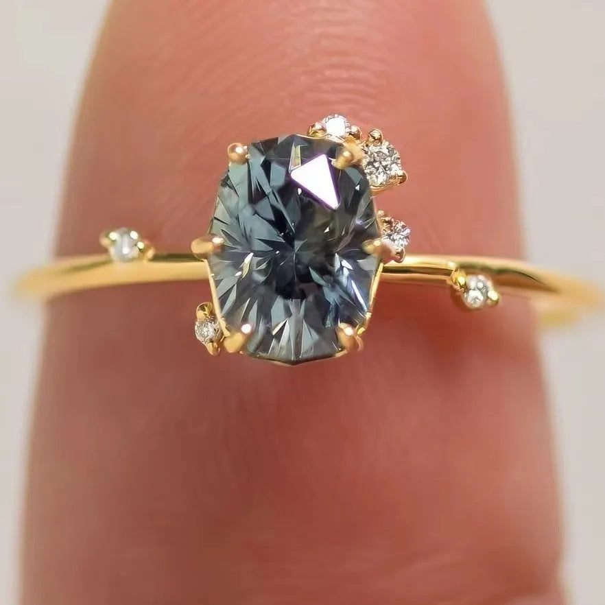 Gold plated floral women's ring with a central green zircon stone.