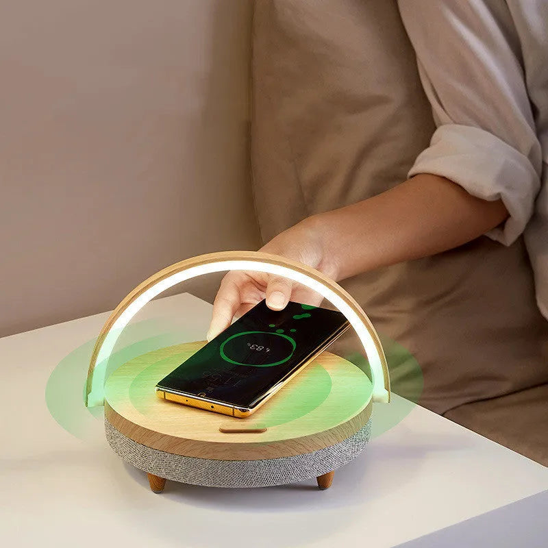 Wireless charging LED night light with Bluetooth speaker in marble finish showing phone on charging pad