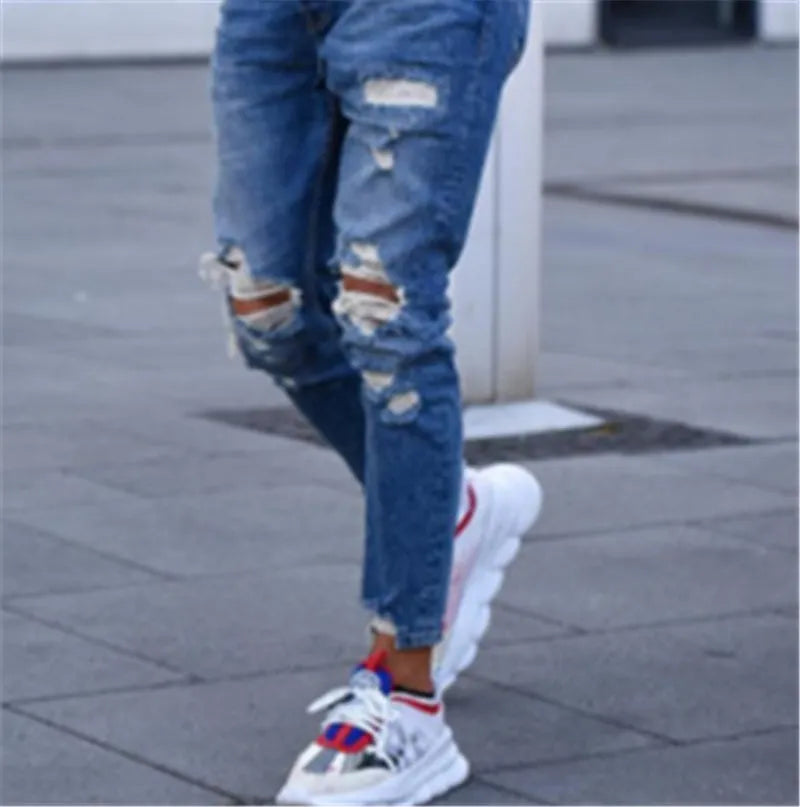 Men's deep blue cotton jeans with distressed hole details on the legs
