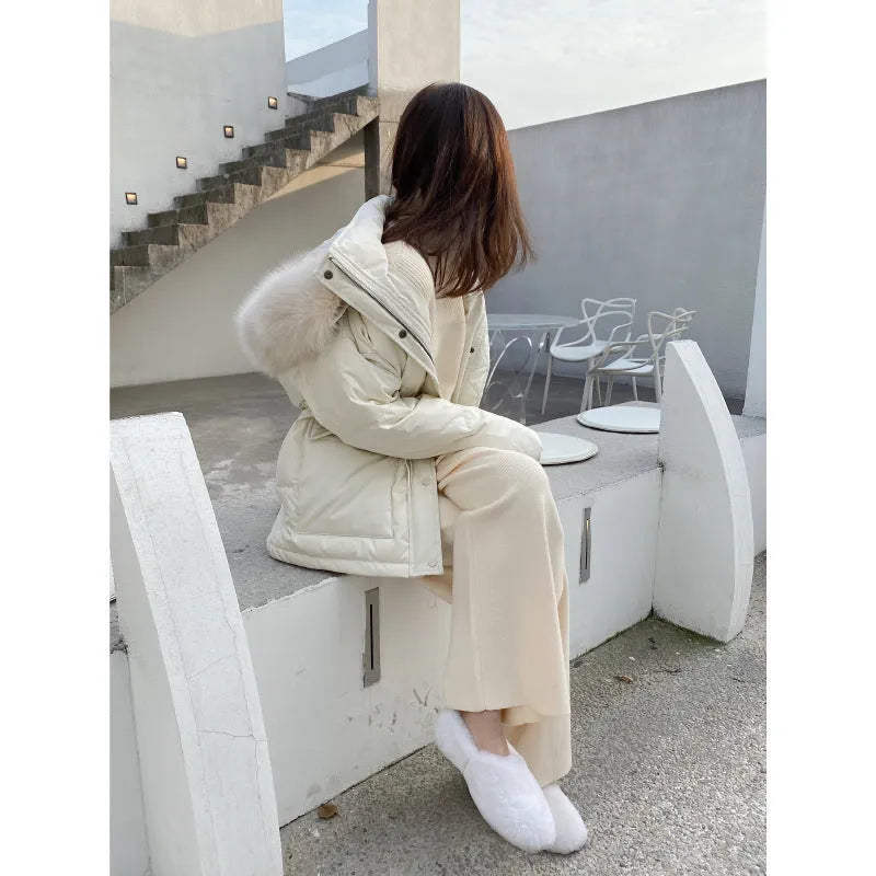 Women's cream white knitted wide-leg high-waist trousers laid flat, showing long straight-leg mopping style.
