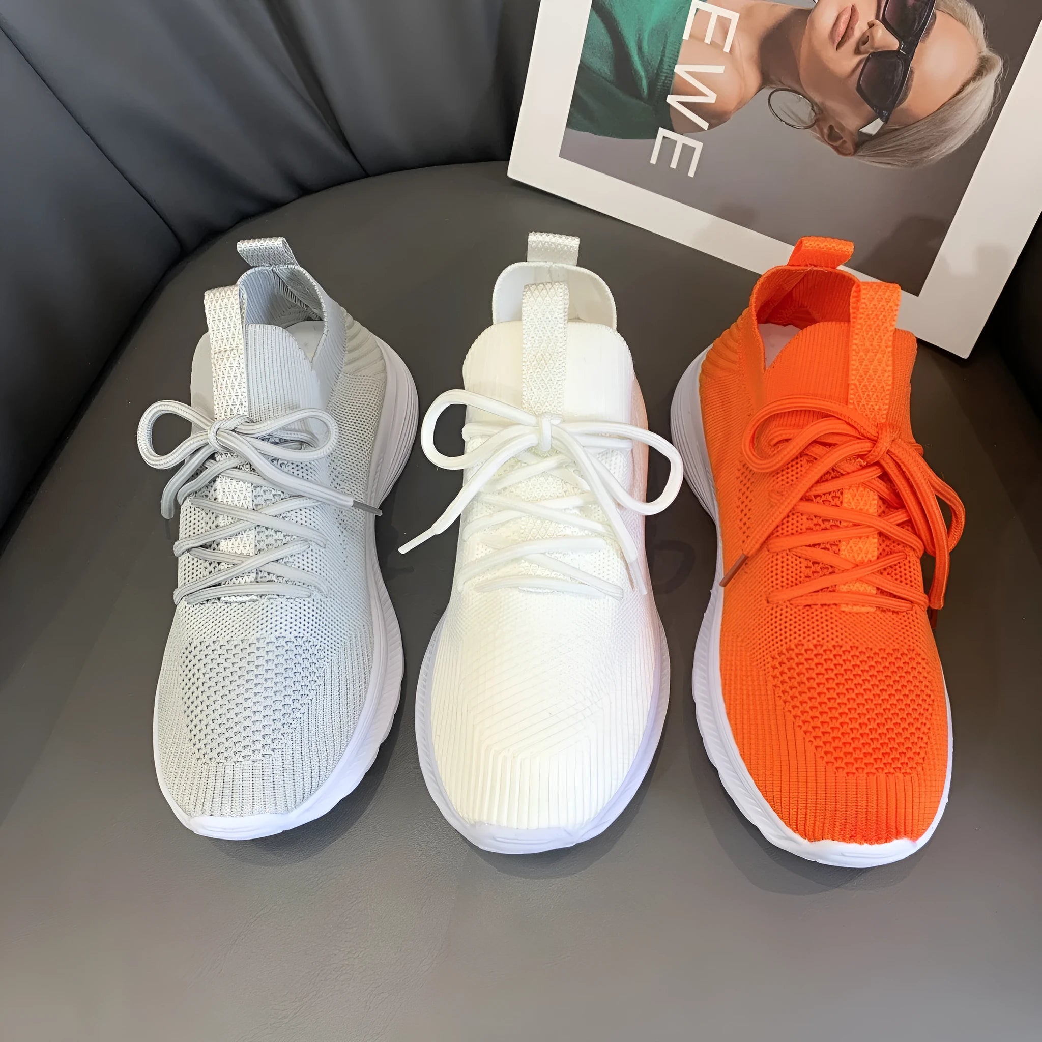 Women's low-top mesh breathable tennis shoes in creamy white, orange, and gray colours.