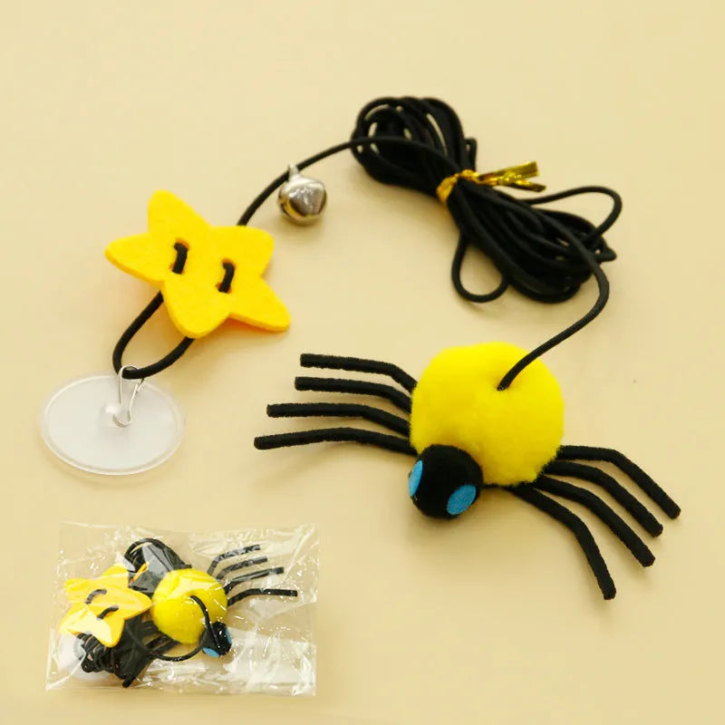 Red and yellow cat door toy with elastic rope, feather, bell, and spider dangling for interactive play.