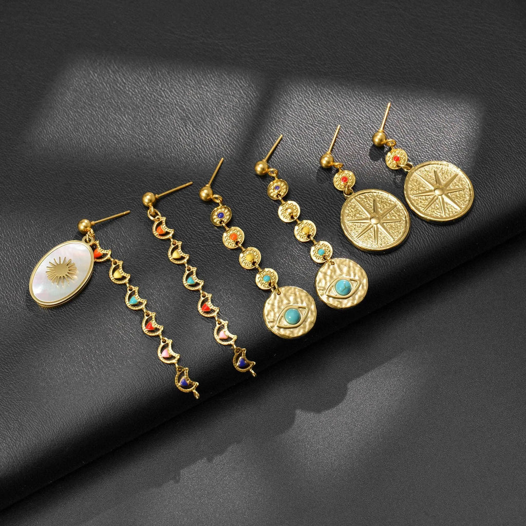 Stainless steel geometric drop earrings showing Eight Awn Star, Eye, and Shell Sun design options.