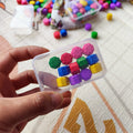 Childhood nostalgic toy claw stone game set with plastic grasping stones in mixed colours