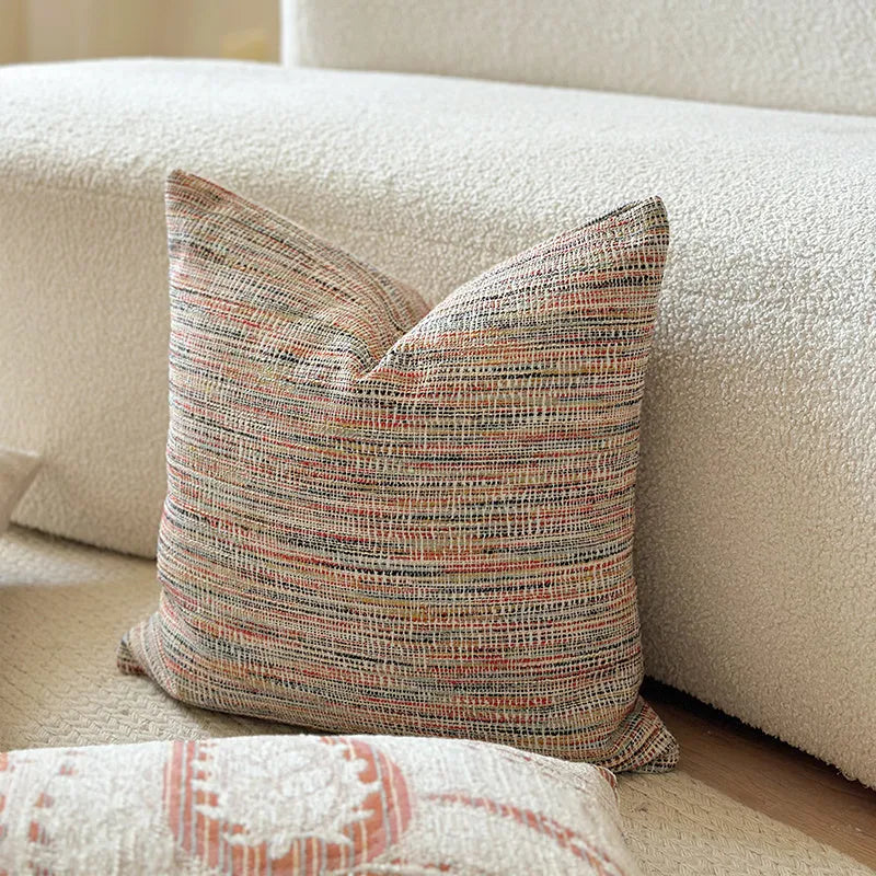 American-style paisley jacquard sofa backrest cushion in Amber colour on a grey sofa.