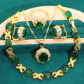 Gold-plated jewellery set with necklace, earrings, ring, and bracelet featuring blue cubic zirconia stones.