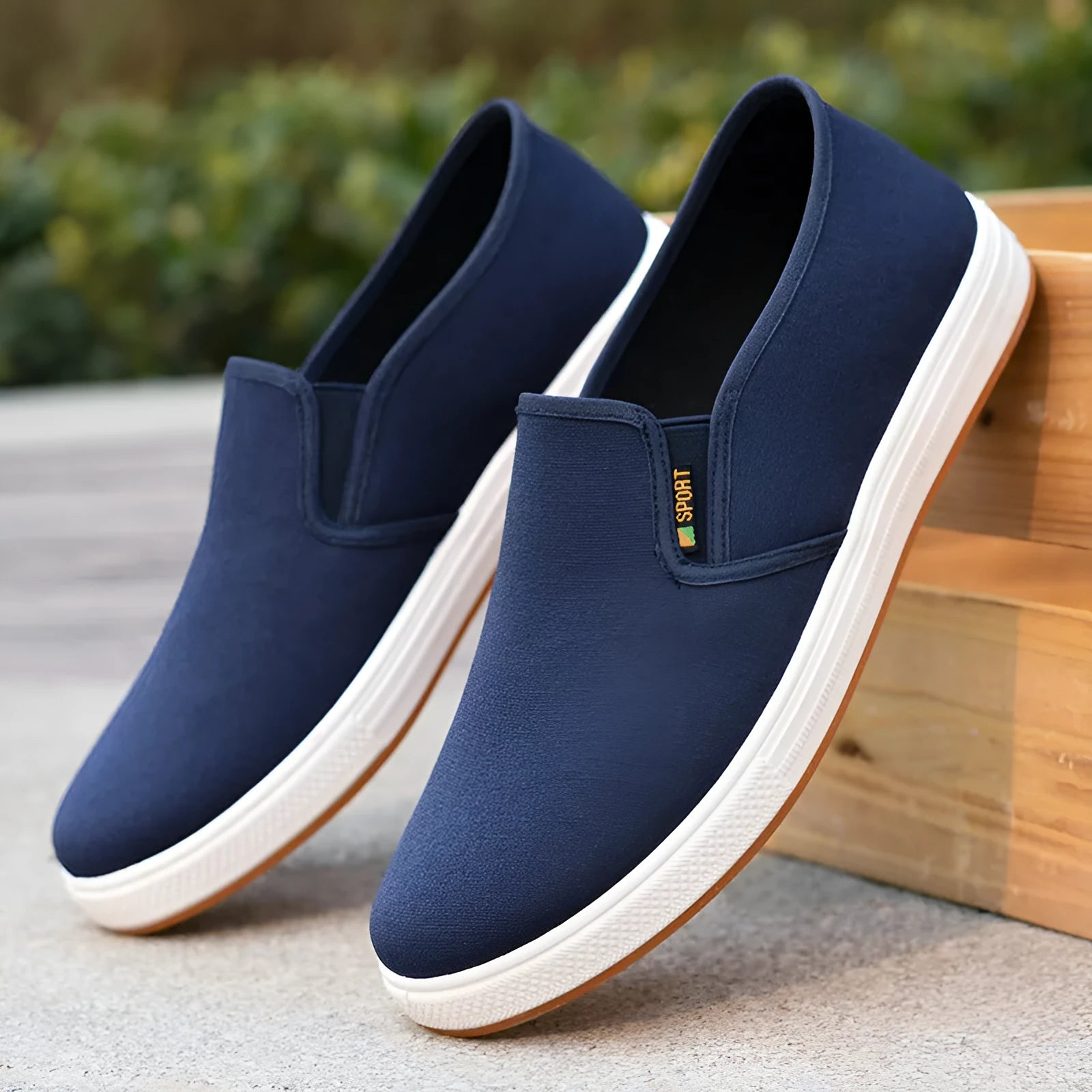 Men's black low-top canvas slip-on shoes with round toe and shallow mouth design on a white background.