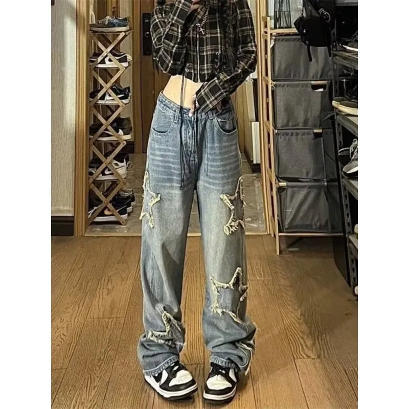 Blue high waist women's denim trousers with a straight wide-leg cut on a size chart.