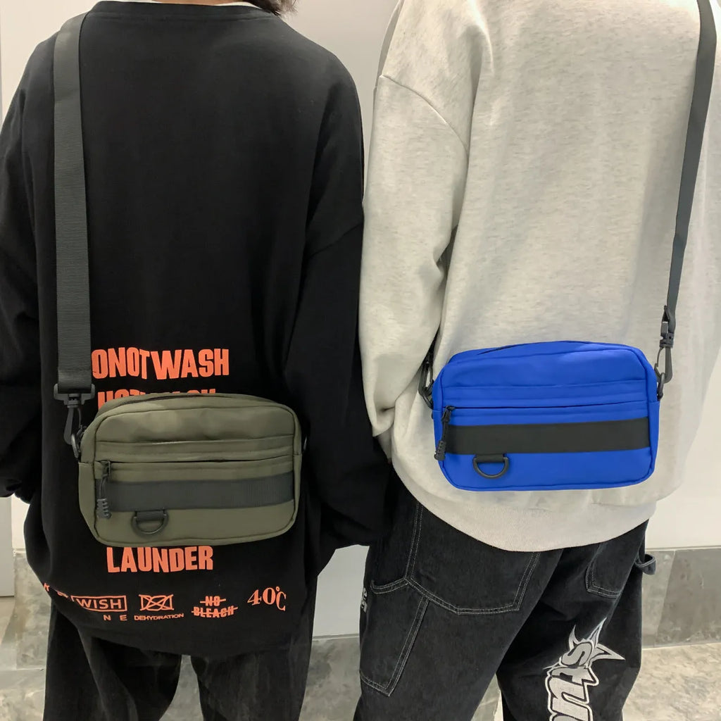 Men's black crossbody messenger bag with visible sewing thread details, shown with dimensions of 22cm length