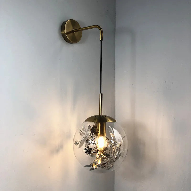 Modern glass wall lamp with golden flower pattern, 20cm size, emitting warm LED light.