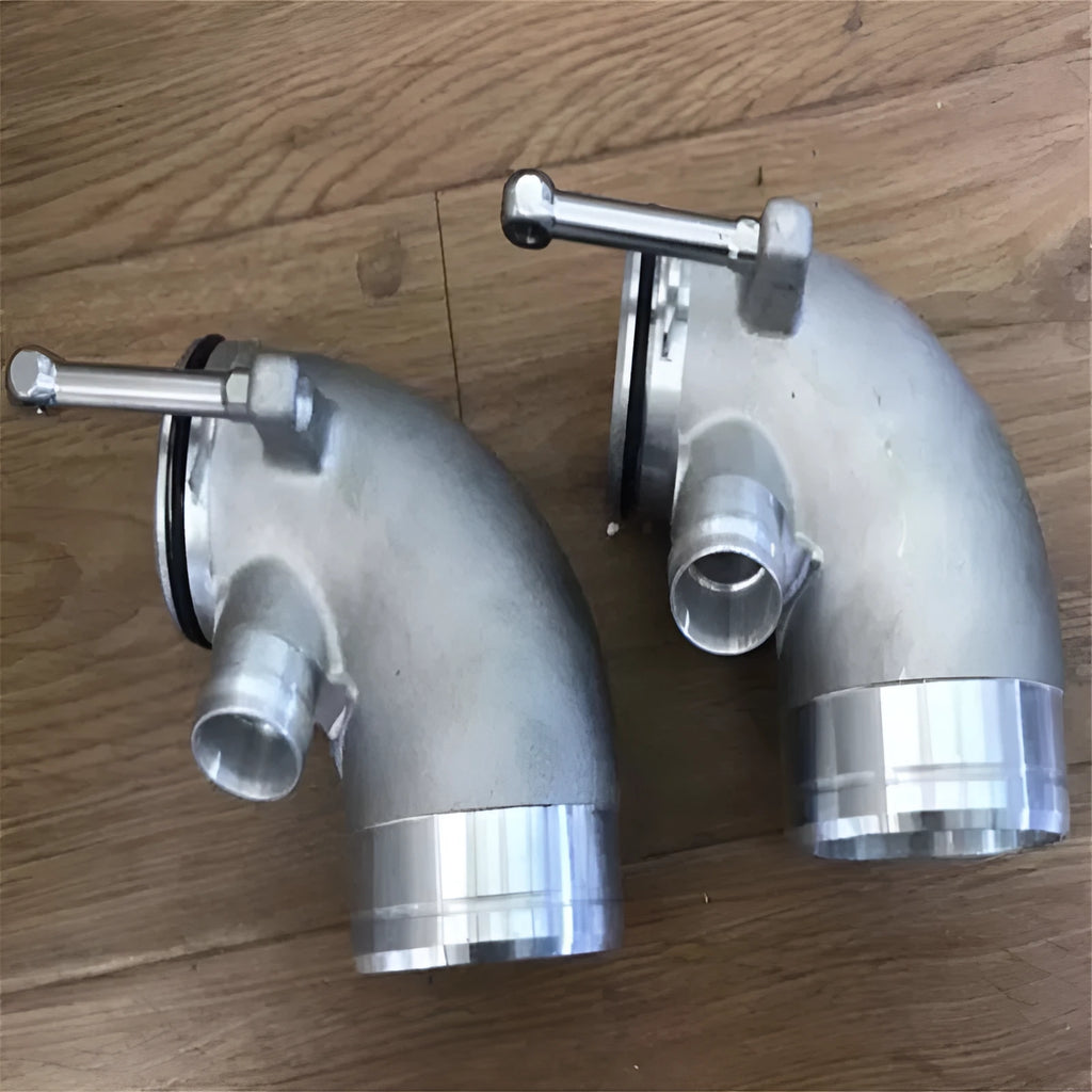 Black aluminium alloy 90 degree turbocharger elbow tube for lateral engine mounting.
