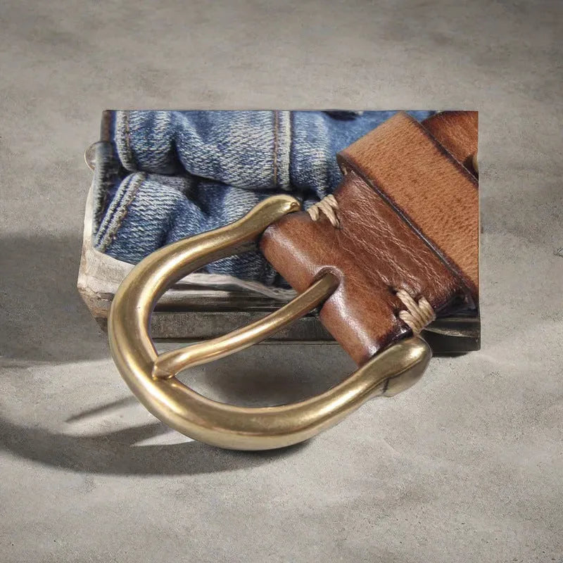 Men's black genuine leather casual belt with a copper pin buckle on a jeans background.