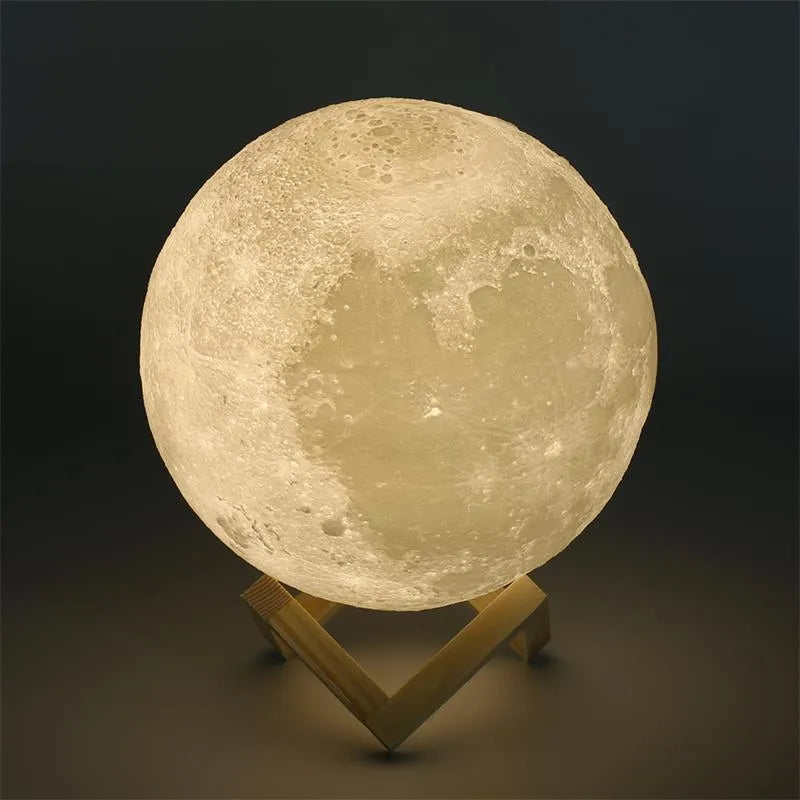 3D printed moon lamp glowing on a wooden stand with touch ring at base