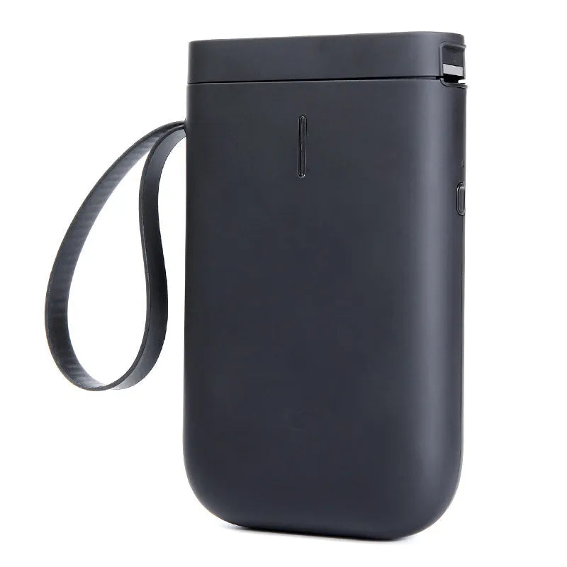 D11 Bluetooth label printer in black colour on a desk next to a smartphone showing the label design app.