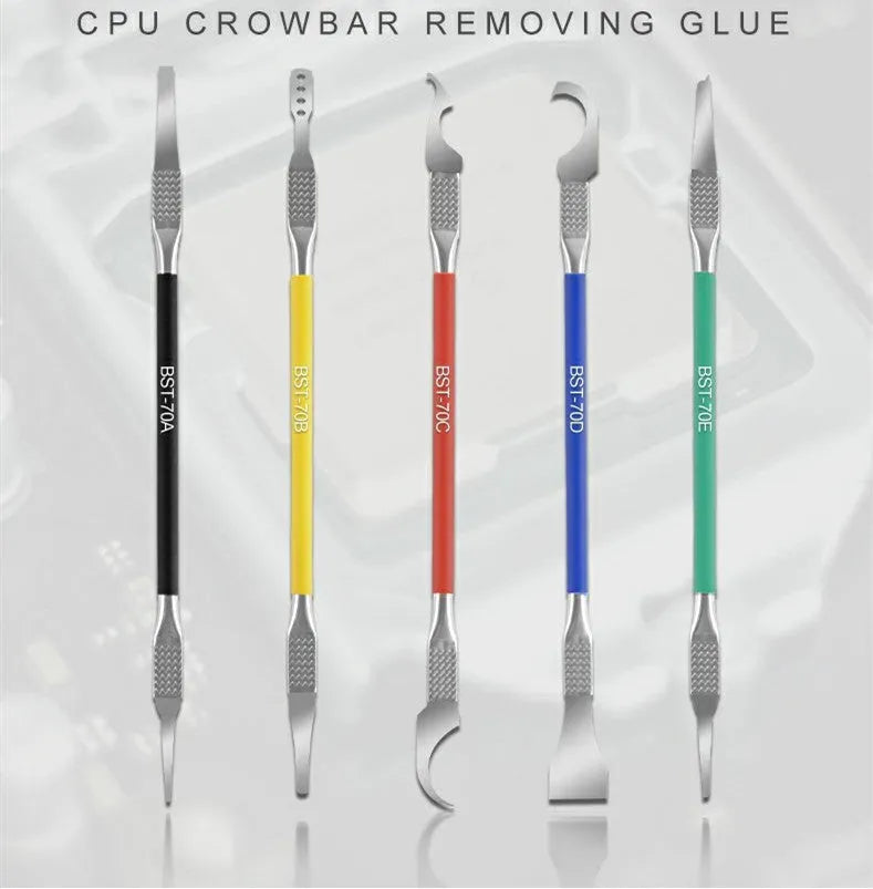 Five stainless steel plastic removal pry tools for electronics disassembly on a work surface.