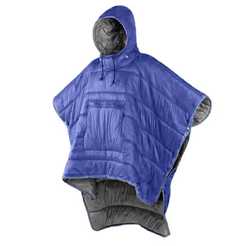 Adult wearing grey nylon cloak sleeping bag as wearable camping blanket outdoors