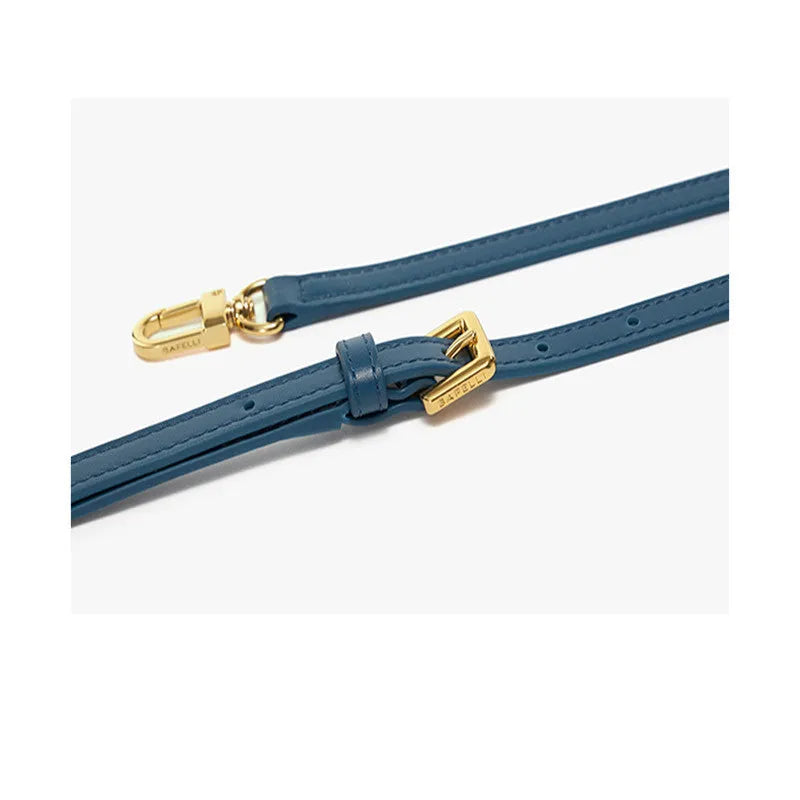 Women's leather wing handbag in blue with buckle decoration and shoulder strap