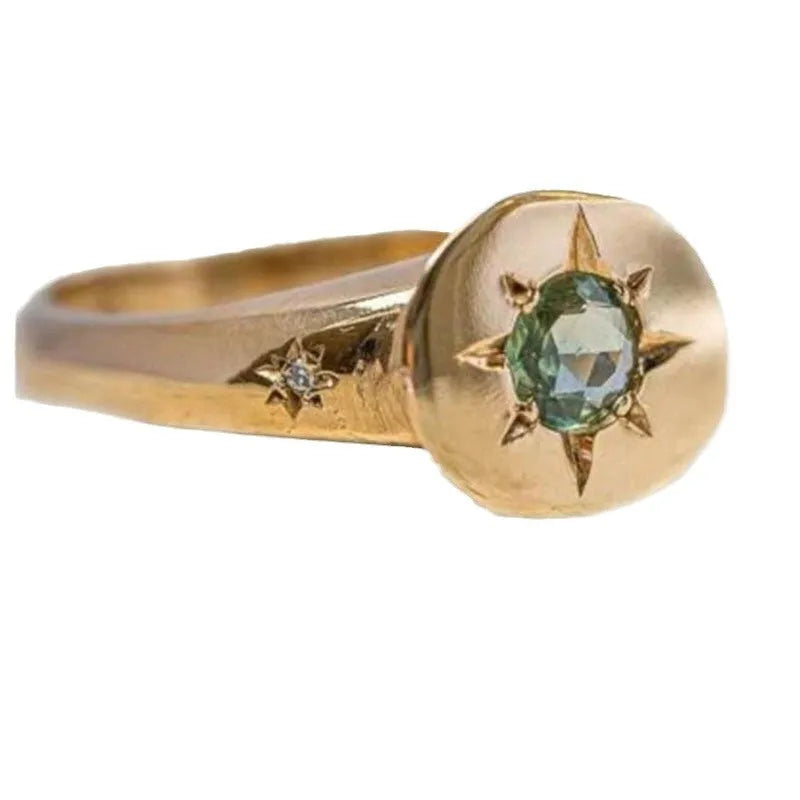 Gold-colour adjustable ring with a star-shaped design and oval asterism zircon.