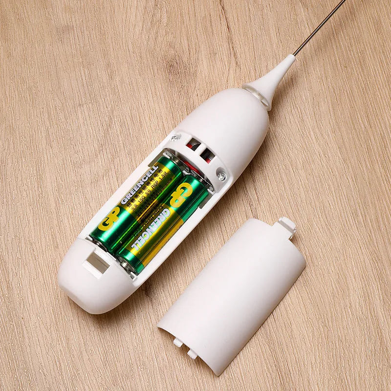 Black and white handheld electric milk frother with whisk attachment for coffee and beverage preparation