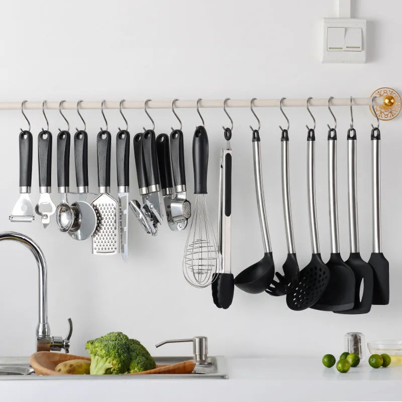 Black silicone and stainless steel cooking utensil set with 16 pieces including spatulas and spoons.