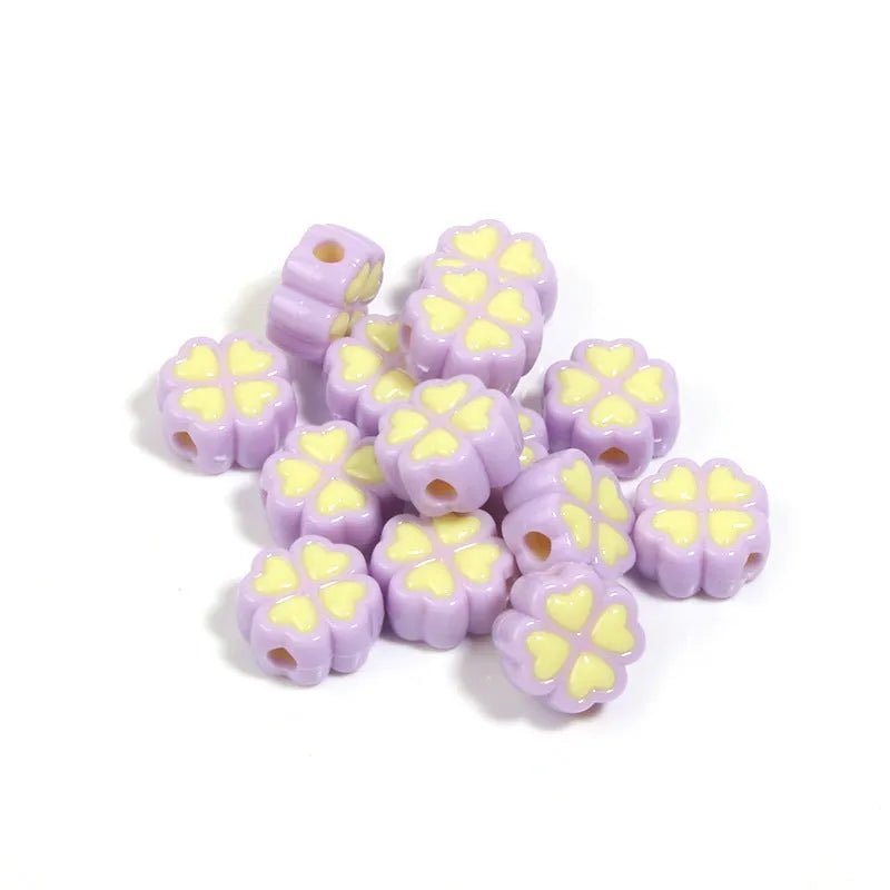 Mixed colour frosted acrylic four-leaf clover shaped beads, each 15mm in size.
