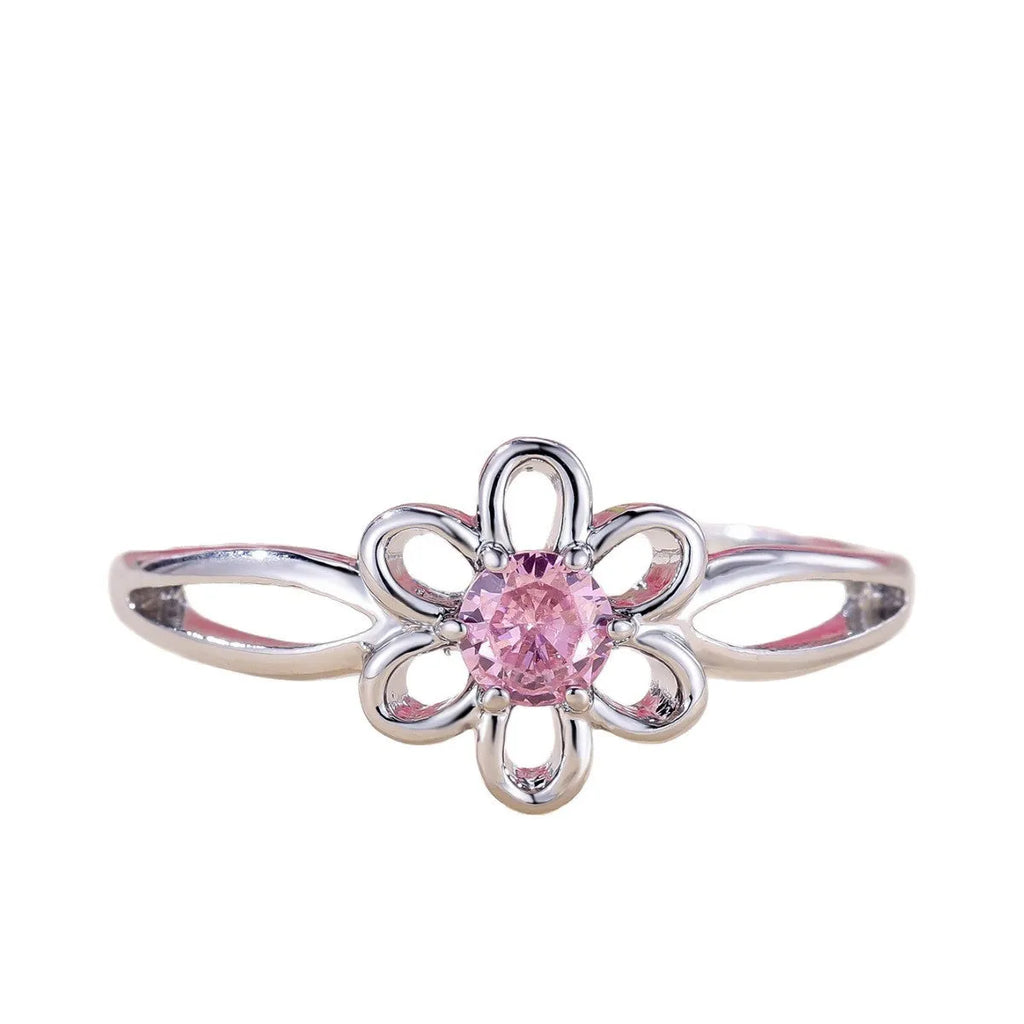 Close-up of a women's hollowed flower ring with a platinum pink diamond electroplated finish.
