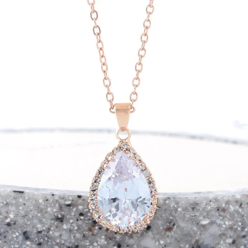 Women's alloy water drop necklace with rose gold electroplated colour and rhinestone inlays on a geometric pendant.