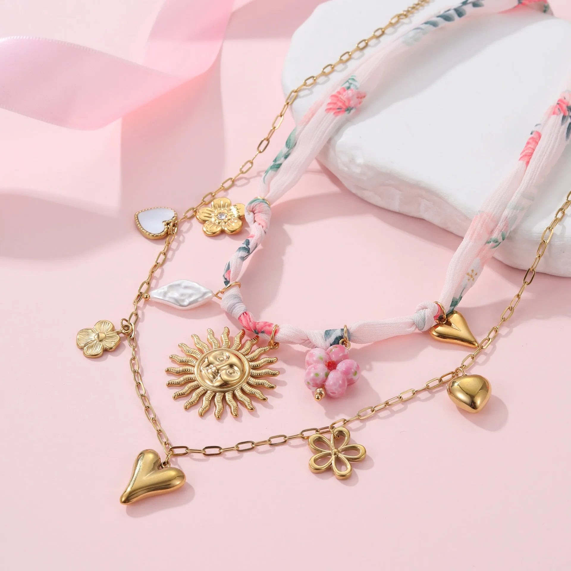 Gold plated stainless steel necklace with a choice of a geometric sun or heart pendant on a 41-50cm chain.
