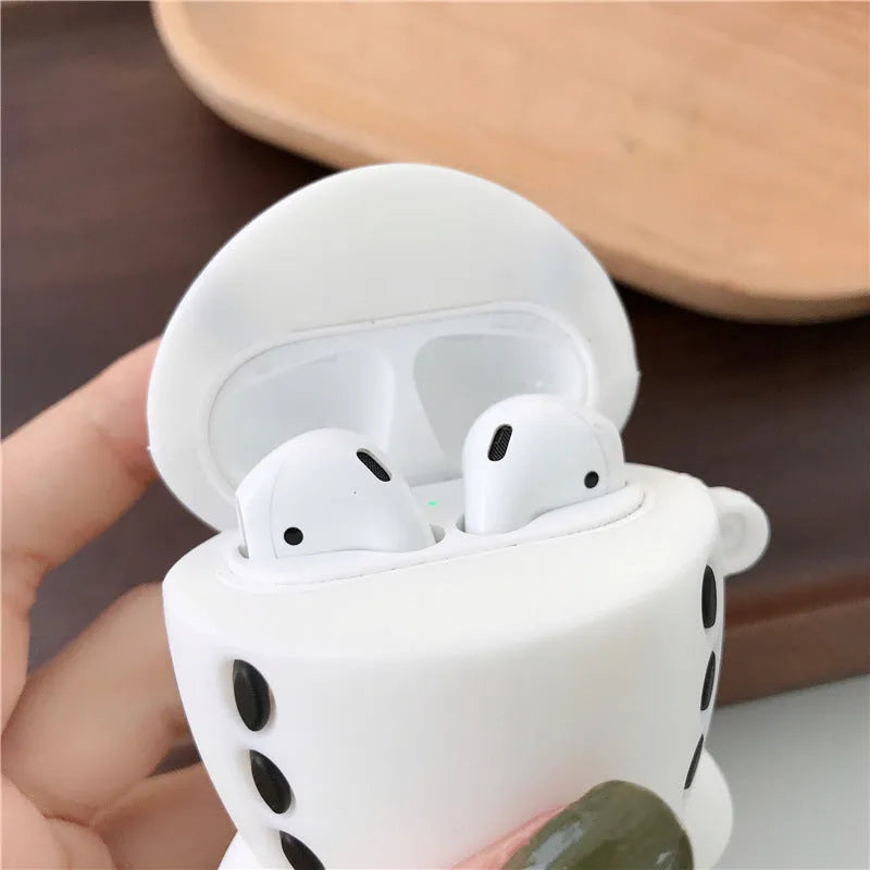 Silicone protective case for Apple AirPods with flip-top cover, cartoon aeroplane headset design, and detachable hook.