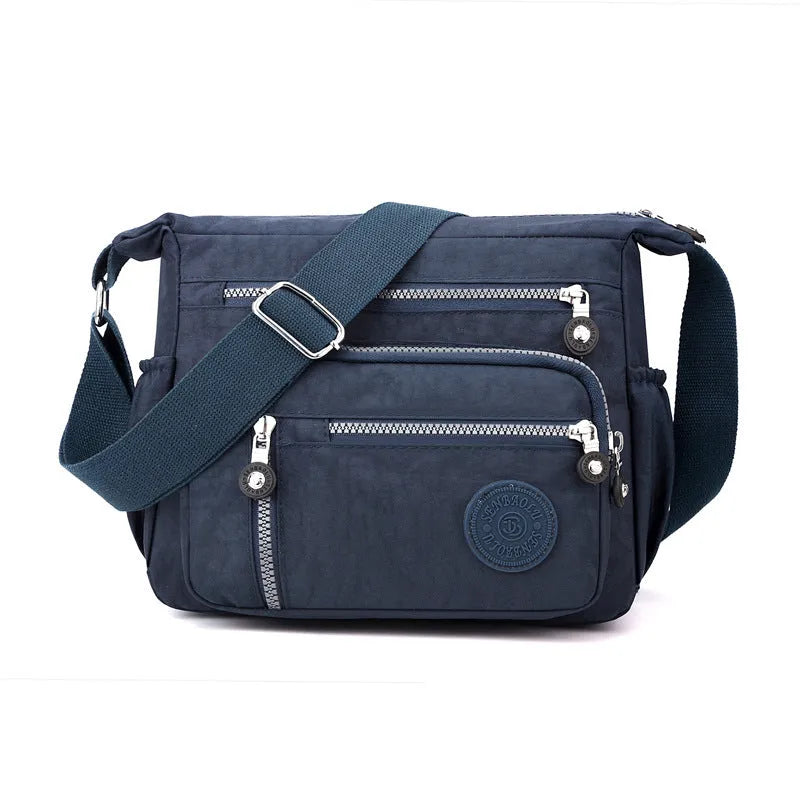 Nylon soft shoulder messenger bag in square vertical shape with single strap.